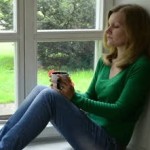 stock-footage-sad-worried-woman-girl-sit-on-wooden-window-sill-and-drink-coffee-tea